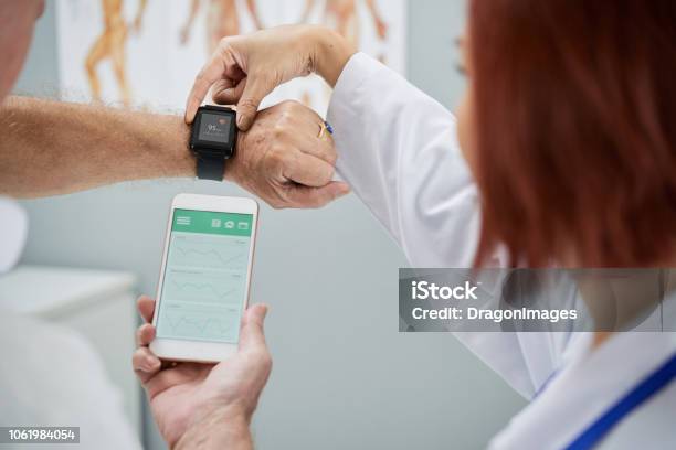 Synchronizing Devices Stock Photo - Download Image Now - Healthcare And Medicine, Wearable Computer, Smart Watch
