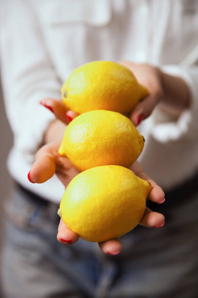 istock Young woman hands with lemon 1061990196