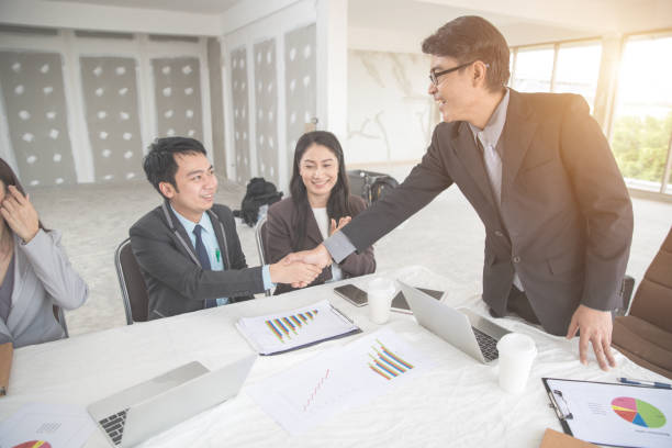 istock business people shaking hand after completed project during meeting using as background (concept of teamwork and partnership) 1061992876