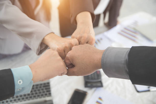 istock business people giving first bump after completed project during meeting using as background (concept of teamwork and partnership) 1061992974