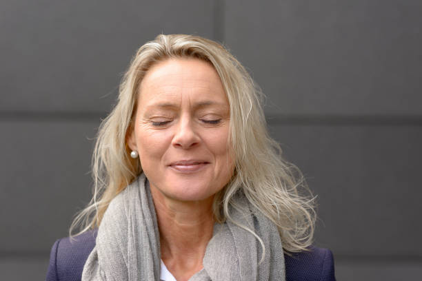 istock Mature blond woman with closed eyes 1061998164