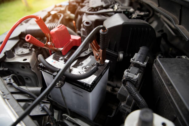 istock Mechanic charging old car with electricity trough jumper cables 1062001202