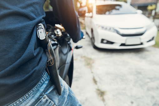 Guy With Knife Tries To Steal Motorcycle Thief With Gun On Motorcycle Trying To Steal Car Stock Photo - Download