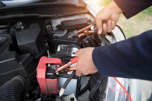 istock Mechanic hand charging car with electricity trough jumper cables 1062001220