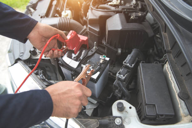 istock Mechanic hand charging car with electricity trough jumper cables 1062001274