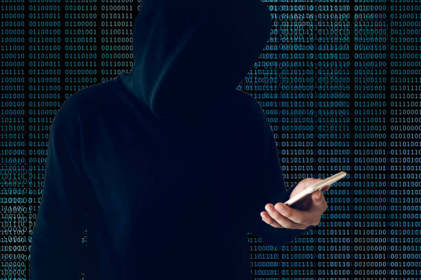 istock hacker wearing black hooded with cell phone hacking and stealing big data from internet on blue binary code background 1062004668