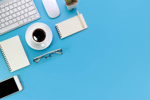 istock top view blue pastel office desk with computer, office supplies, cell phone, and black coffee cup 1062008396