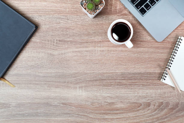 istock technology working wood table with laptop computer, coffee cup and plant 1062008506