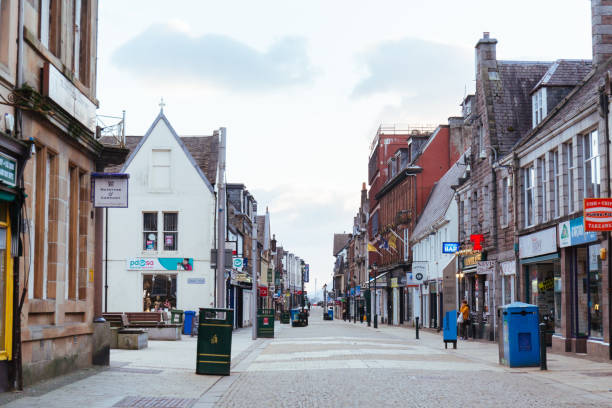 High Street in Fort William, Scotland Fort William, UK - March 17, 2018: Empty High Street in Fort William town out of season on cloudy spring day, Highlands, Scotland fort william stock pictures, royalty-free photos & images