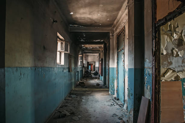 istock Empty corridor in old abandoned ruined building, scary atmosphere, perspective 1062010786