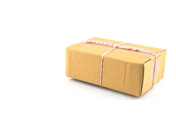 brown paper box  tied with red and white string ready to send isolated - string package brown paper imagens e fotografias de stock