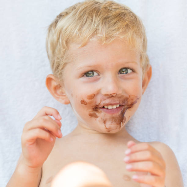 istock child smiling with dirty chocolate face close up 1062017300