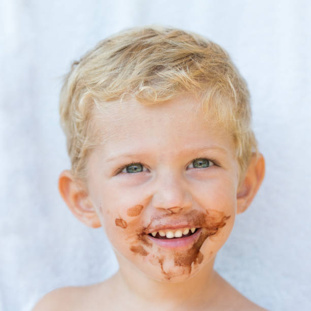 istock baby boy with chocolate on his face close up 1062017310