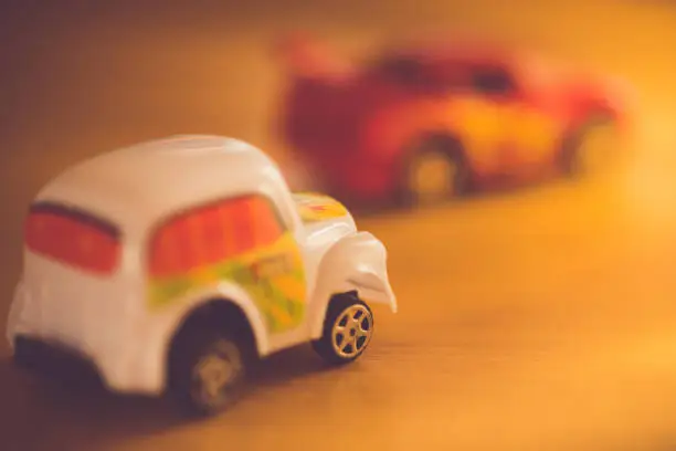 two toy cars taxi and sportcar in bright light