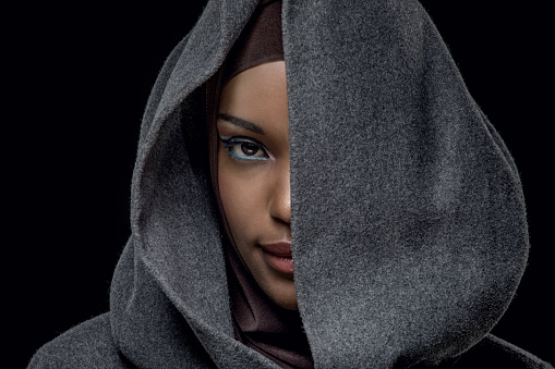 Beautiful Muslim Woman wearing winter hijab and hood in luxury studio shot