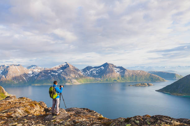 istock Nature landscape photographer using tripod and dslr camera outdoors. 1062029222