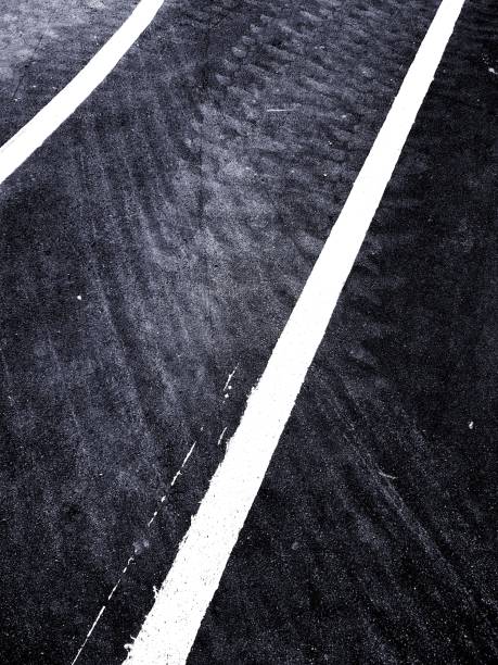 istock New asphalt road with fresh paint white lines. 1062033152