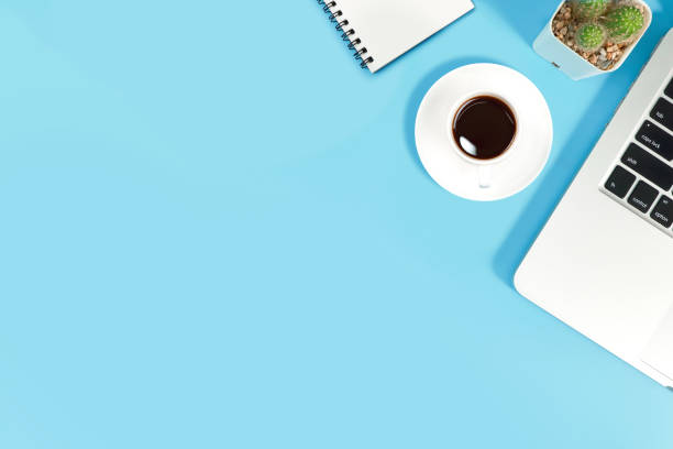 istock business office table with workspace, laptop computer, coffee cup, notebook, pencil, plant and cell phone on blue pastel background 1062033300