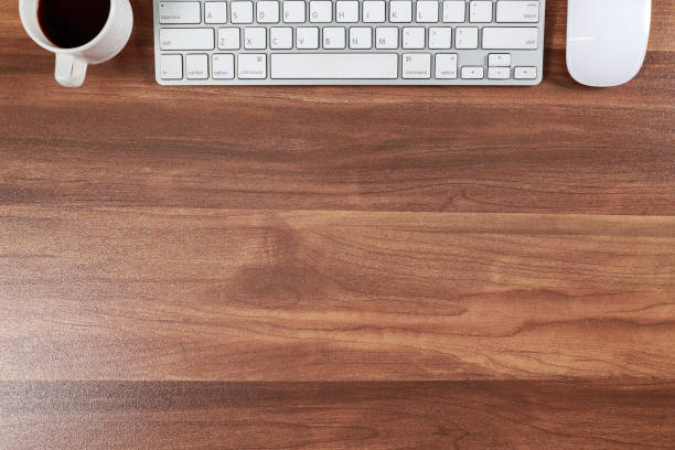 istock wooden workspace business desk with computer and coffee 1062033362