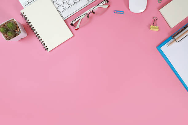istock flat lay workspace table with laptop computer, office supplies, coffee cup, cell phone, and coffee cup on pink background 1062033394