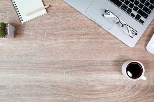 istock technology working wood table with laptop computer, coffee cup and plant 1062033442