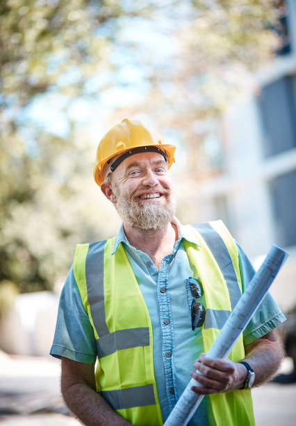 istock Mature male construction worker in hard hat smiles 1062033556