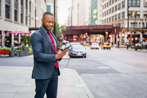 istock Smiling Businessman using his mobile phone in Chicago 1062037406