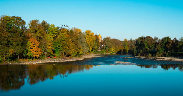 istock trees in autumn color along river Lech.   Landsberg am Lech, Germany 1062037730