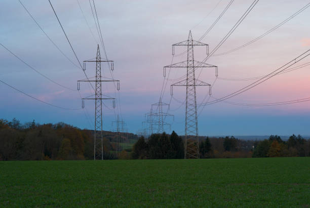 220 kilovolt and 380 kilovolt Electric Power Pylons at Dawn - 6 phases and one ground wire