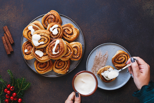 Soft pumpkin cinnamon rolls filled with cinnamon swirl and topped with maple cream cheese, traditional baked Christmas treat