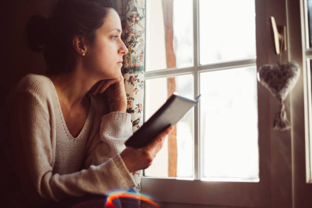 istock Woman in holiday villa reading an e-book 1062043704
