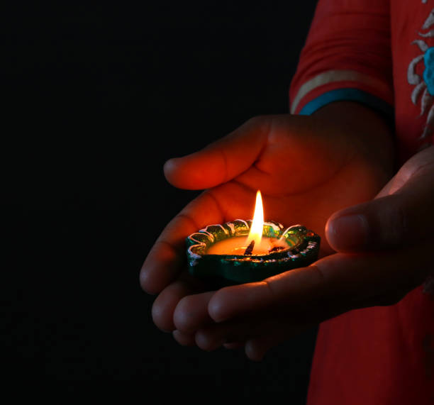 istock Illuminated lamp/diya holding in hand 1062048116
