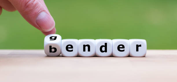istock Hand is turning a dice and changes the word gender to bender 1062050976