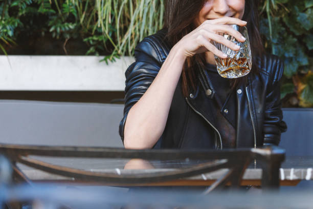 Woman drinking whiskey stock photo