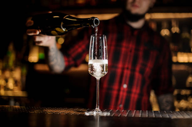 istock Bartender pouring a delicious champagne from a bottle to a glass 1062062180