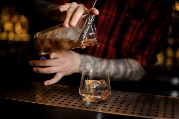 istock Bartender pouring an alcohol making a James Cook cocktail 1062062664
