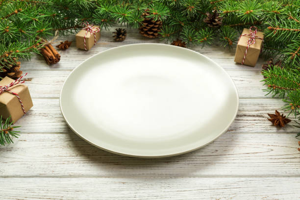 istock Perspective view. Empty plate round ceramic on wooden christmas background. holiday dinner dish concept with new year decor 1062065182