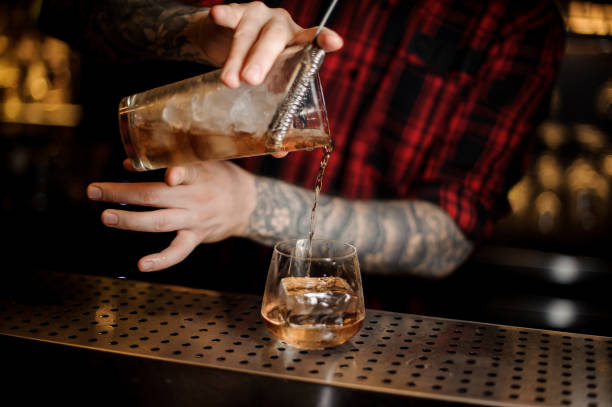 istock Bartender pouring an alcohol making a delicious James Cook cocktail 1062065760