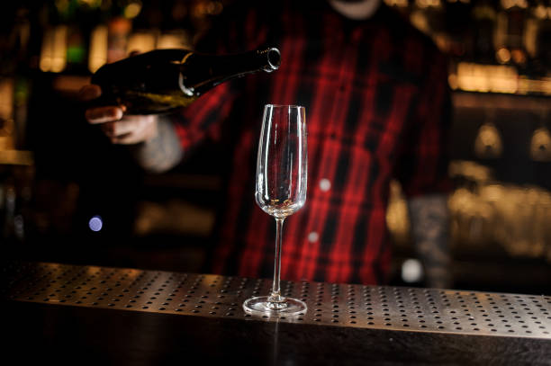 istock Bartender pouring a champagne from a bottle to a glass 1062066010