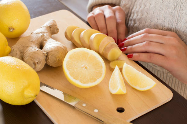 istock young woman slicing lemons and ginger root 1062066158