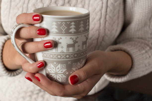 istock young wooman holding a cup of coffee 1062066360