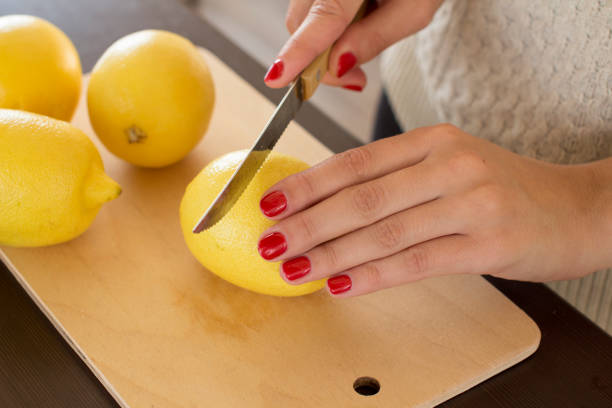 istock young woman slicing lemons 1062067338