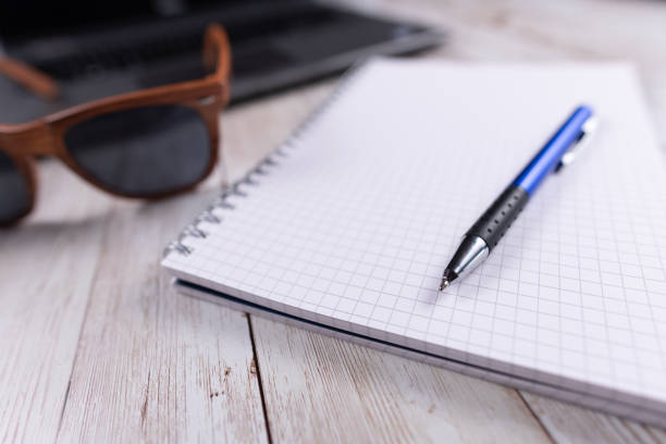 istock Planning for a holiday with sunglasses and notepad 1062069236