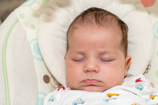 istock Cute newborn baby boy, sleeping in a swing 1062073044