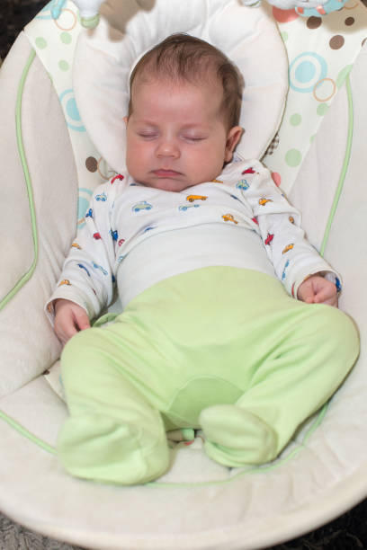 istock Cute newborn baby boy, sleeping in a swing 1062073378