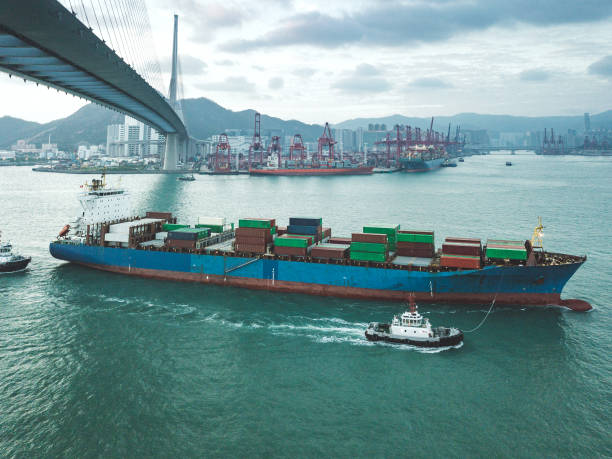 istock Bridge in Hong Kong and Container Cargo freight ship 1062081044