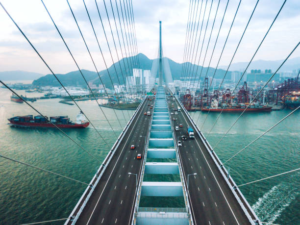 istock Bridge in Hong Kong and Container Cargo freight ship 1062081138
