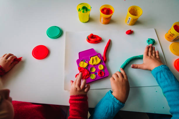 istock kids play with clay molding shapes, learning and play 1062089766