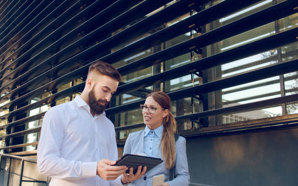 istock Male and female business people browsing on tablet computer 1062097710