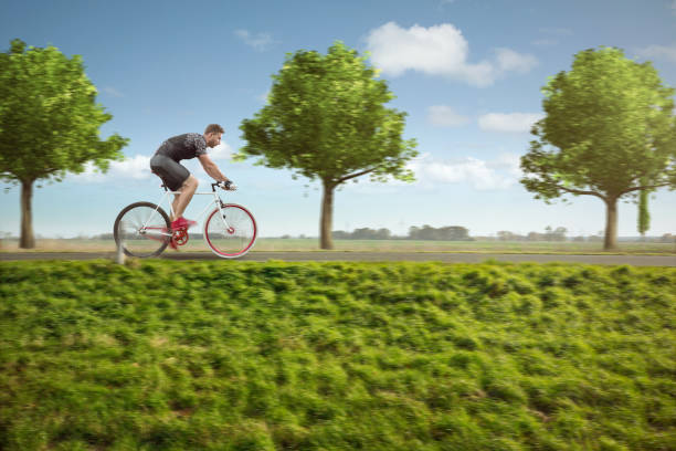 istock Cyclist on a green country road 1062100826